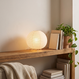 Halden Japanese Lantern Lamp on a shelf in a reading nook