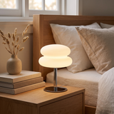 Halden Mushroom Lamp glowing on a bedside table