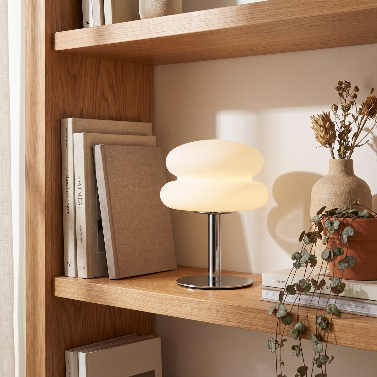 Halden Mushroom Lamp styled on a bookshelf