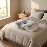 Halden Contour Pillow on a guest bed by a window