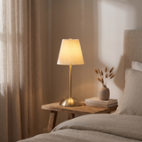 Halden Pleated Touch Desk Lamp glowing on a bedside table