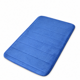 Plush anti-slip bath mat in blue on white background