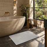 Arc pattern quick-dry bath mat beside a freestanding bath