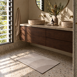 Taupe wave pattern quick-dry bath mat in front of a double vanity