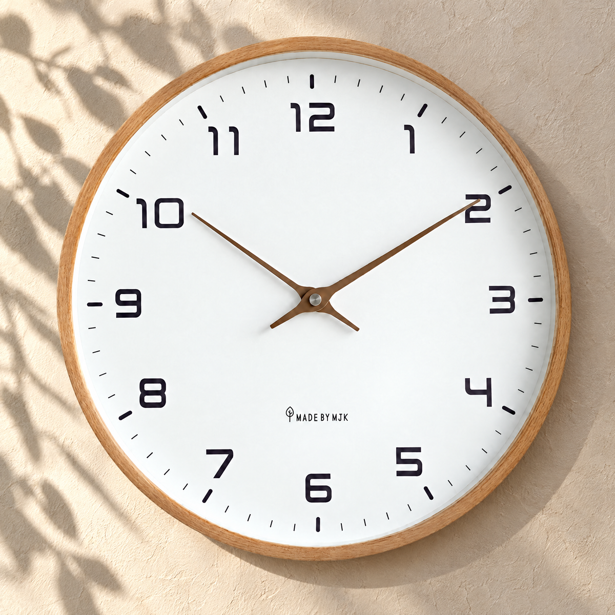 Silent wall clock with brown wood frame on a sunlit plaster wall
