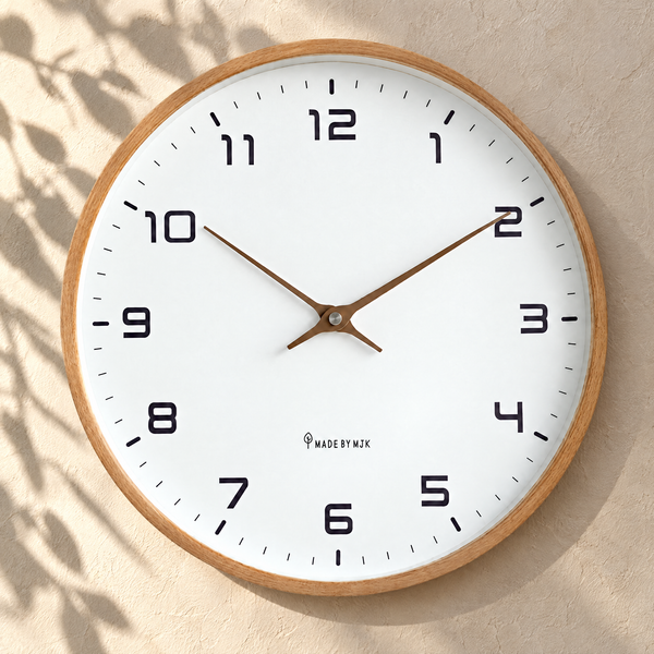 Silent wall clock with brown wood frame on a sunlit plaster wall