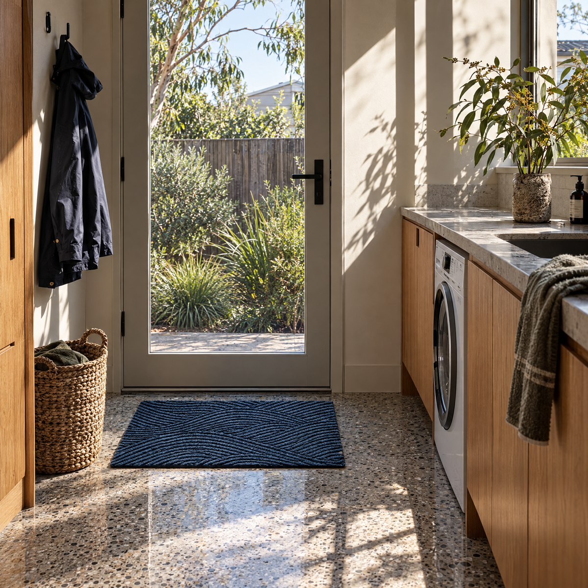 Blue non-slip door mat at a laundry side door