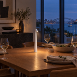 White cordless LED table lamp on a dining table at dusk