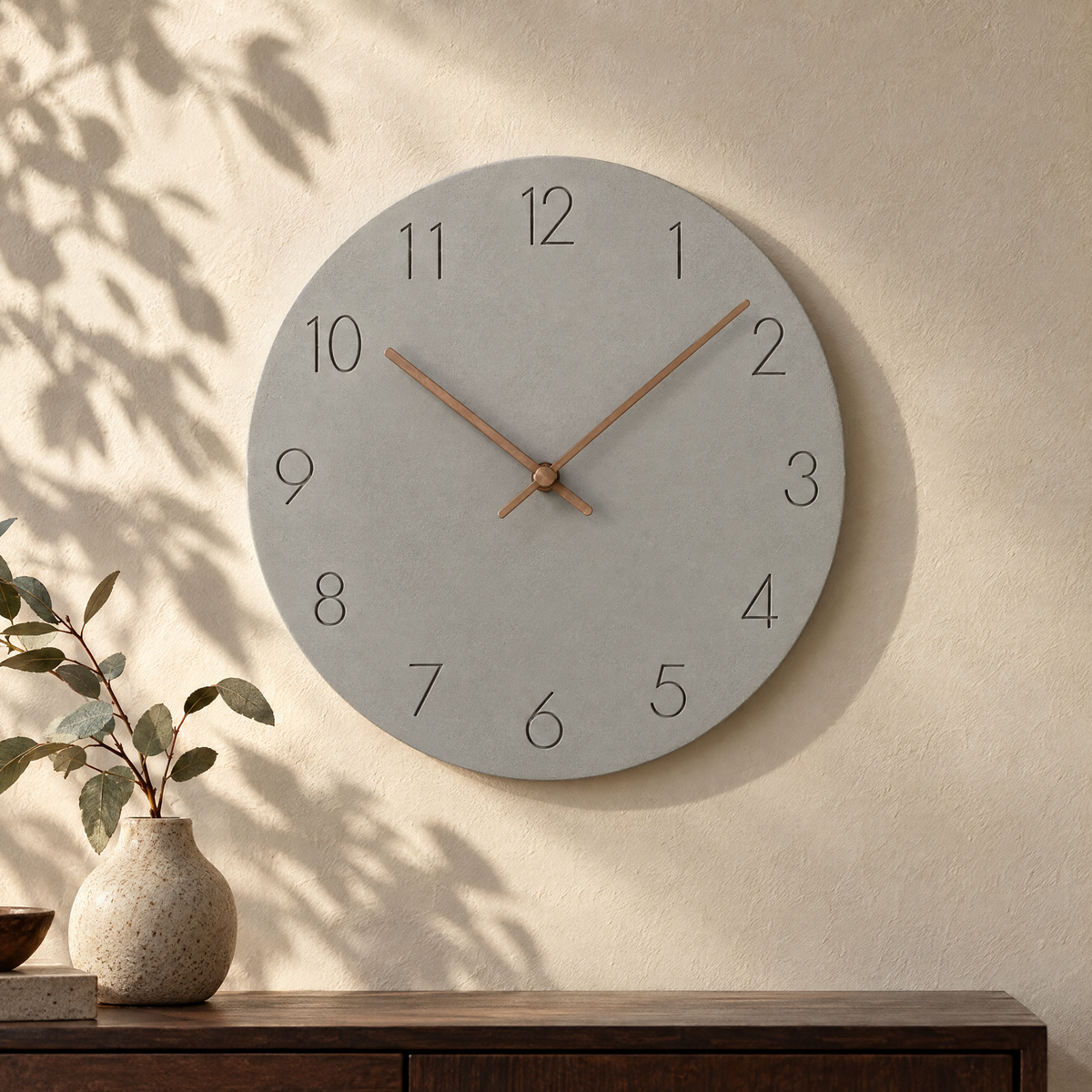 Nork minimalist wall clock in grey on a sunlit plaster wall