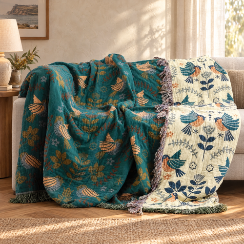 Fugl Reversible Bird Quilt draped over a sofa