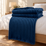 Mys Soft Fleece Blanket on a bed
