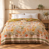 Blom Reversible Cotton Gauze Blanket on a bed