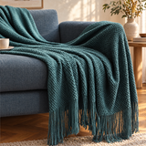 Strik Knitted Throw draped over a sofa