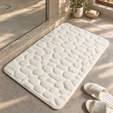 Soft pebble non-slip shower mat in a stone bathroom