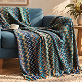 Glad chevron striped throw with tassels on a sofa