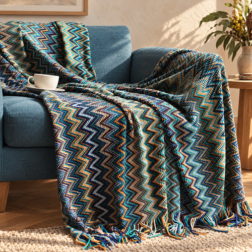 Glad chevron striped throw with tassels on a sofa