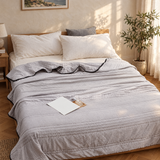 Ice cooling blanket on a bed in a sunlit bedroom