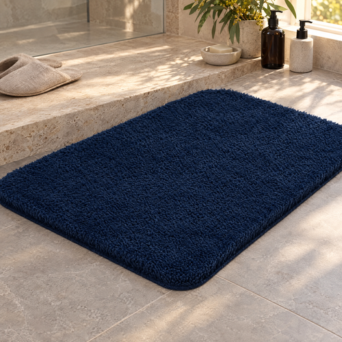 Navy plush shaggy bath rug beside a shower