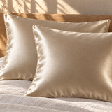 Beige silk pillowcases on pillows close-up v2
