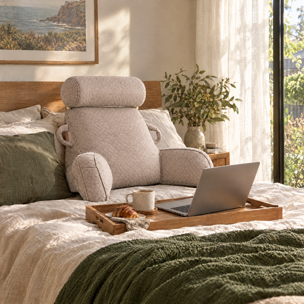 Stöd back cushion with armrests in Taupe, working on a laptop in bed